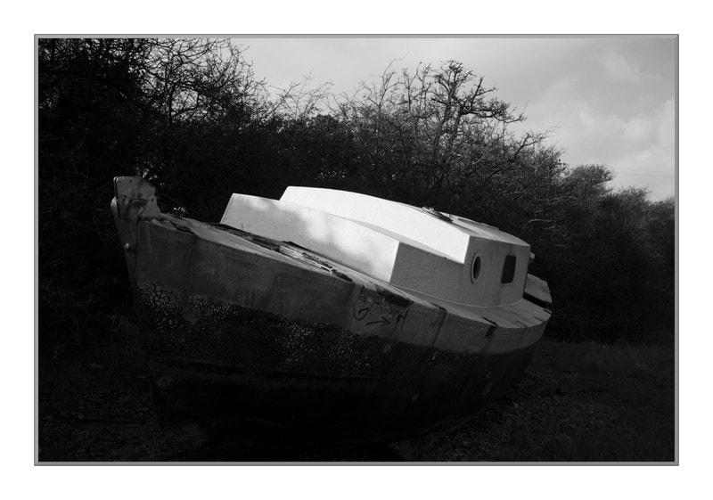 A once wreck of a boat being slowly repaired near Huckers Bow, Kewstoke, W-s-M, UK